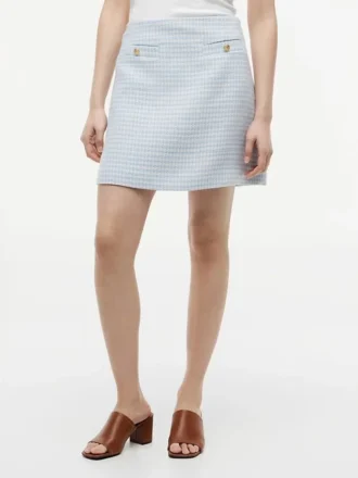 Mini-jupe en tweed à boutons dorés