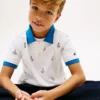 Polo stretch pour enfant avec logo nautique sur toute la surface