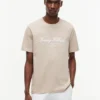 T-shirt rayé avec logo nautique en lettres cursives T-shirt rayé avec logo nautique en lettres cursives