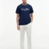 T-shirt rayé avec logo nautique en lettres cursives T-shirt rayé avec logo nautique en lettres cursives