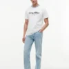 T-shirt rayé avec logo nautique en lettres cursives T-shirt rayé avec logo nautique en lettres cursives